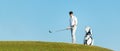 Golfer sport course golf ball fairway.ÃÂ  People lifestyle man approach playing game golf tee off on the green grass. Royalty Free Stock Photo